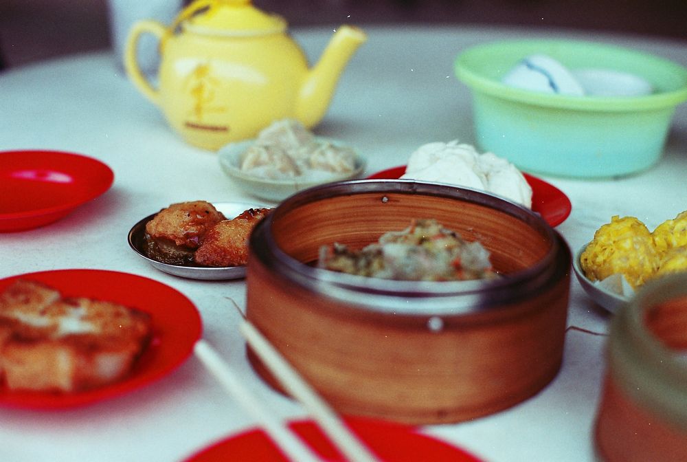 Chinese dim sum with dumplings and tea at a kitchen table. Original public domain image from Wikimedia Commons