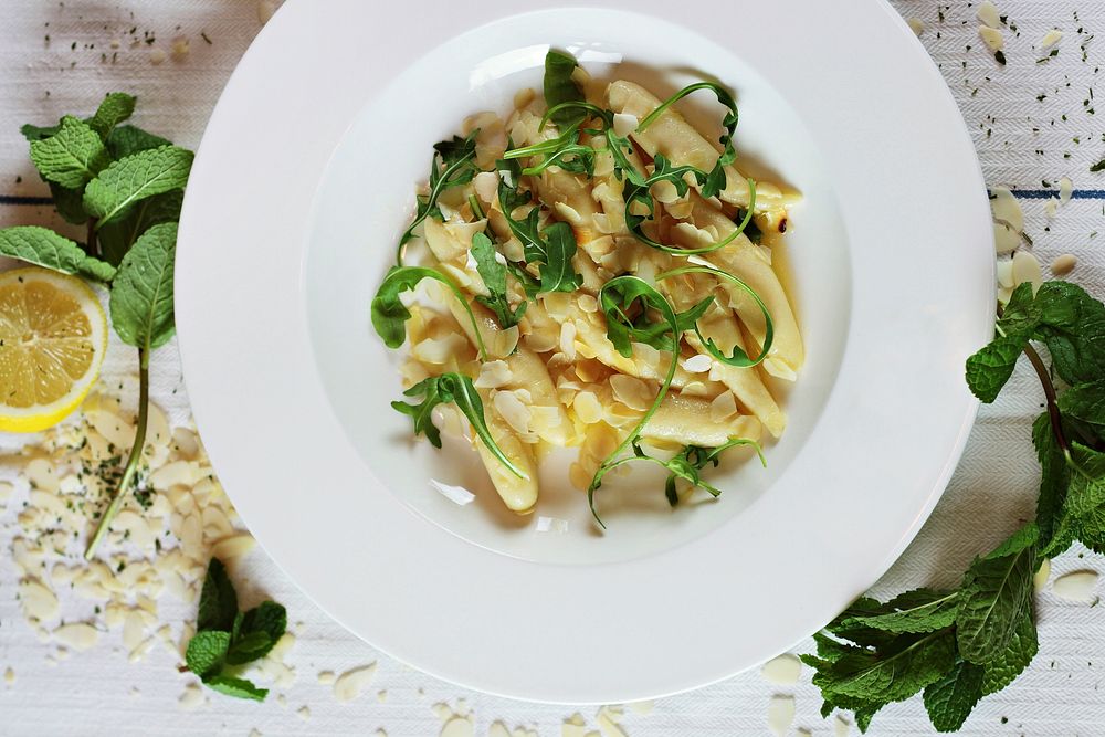 Fresh gnocchi pasta topped with lemon sauce and herbs. Original public domain image from Wikimedia Commons
