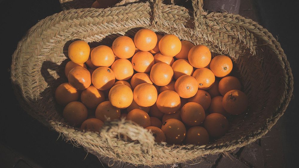 Basket of fresh oranges. Original public domain image from Wikimedia Commons