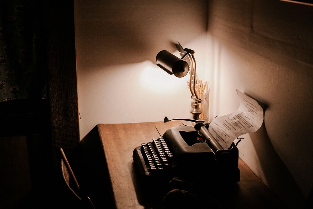 A typewriter and a lamp sitting on a desk Bowen Island. Original public domain image from Wikimedia Commons