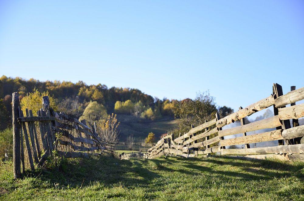 A wooden fence on a hill in the countryside. Original public domain image from Wikimedia Commons