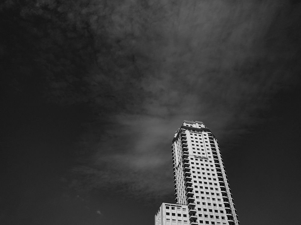 Black and white view of the Torre de Madrid with a dark sky. Original public domain image from Wikimedia Commons