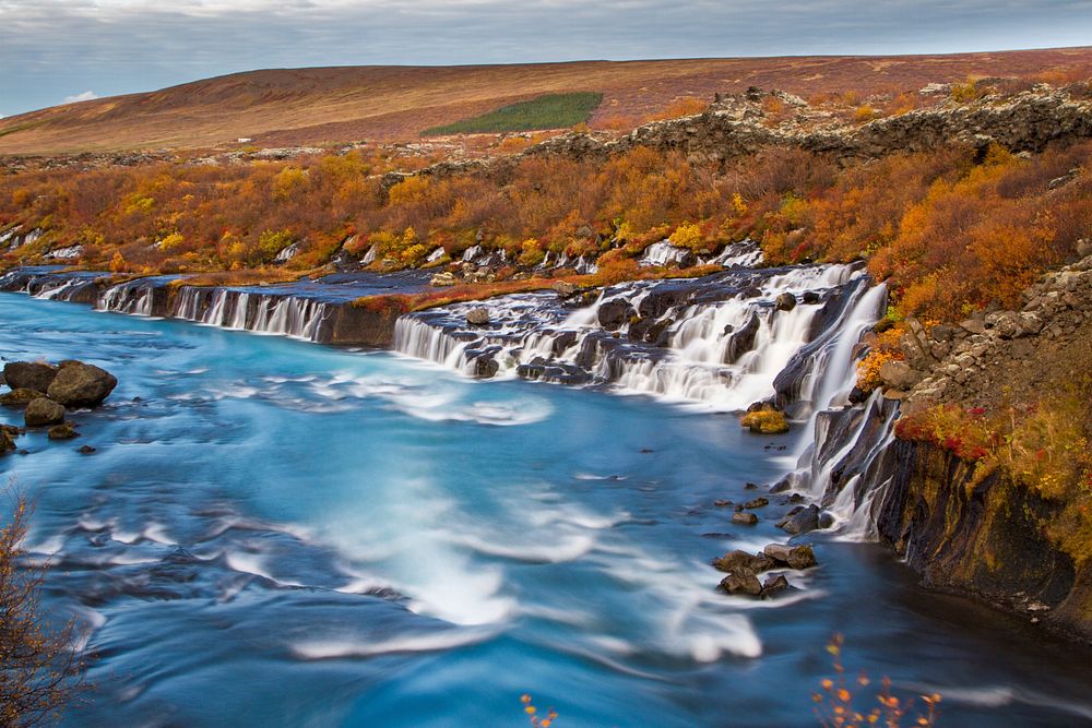 Autumn waterfalls from rocky edge. Original public domain image from Wikimedia Commons