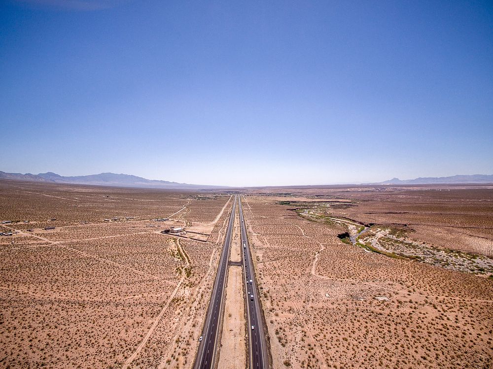 Highway roads divide the rocky desert terrain in Arizona. Original public domain image from Wikimedia Commons