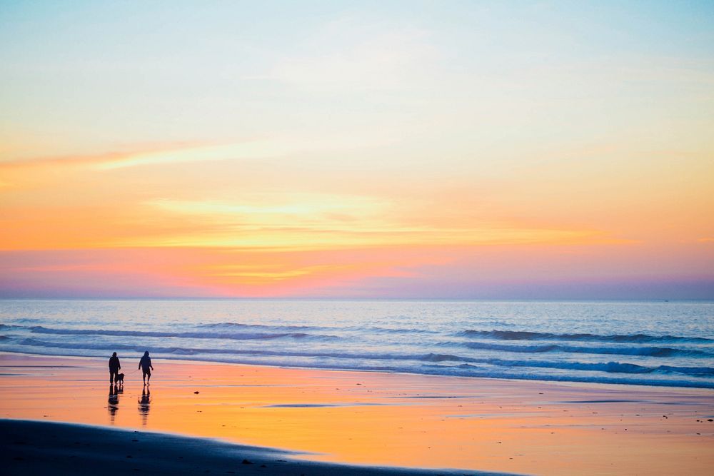 People walking on beach with sunset. Original public domain image from Wikimedia Commons