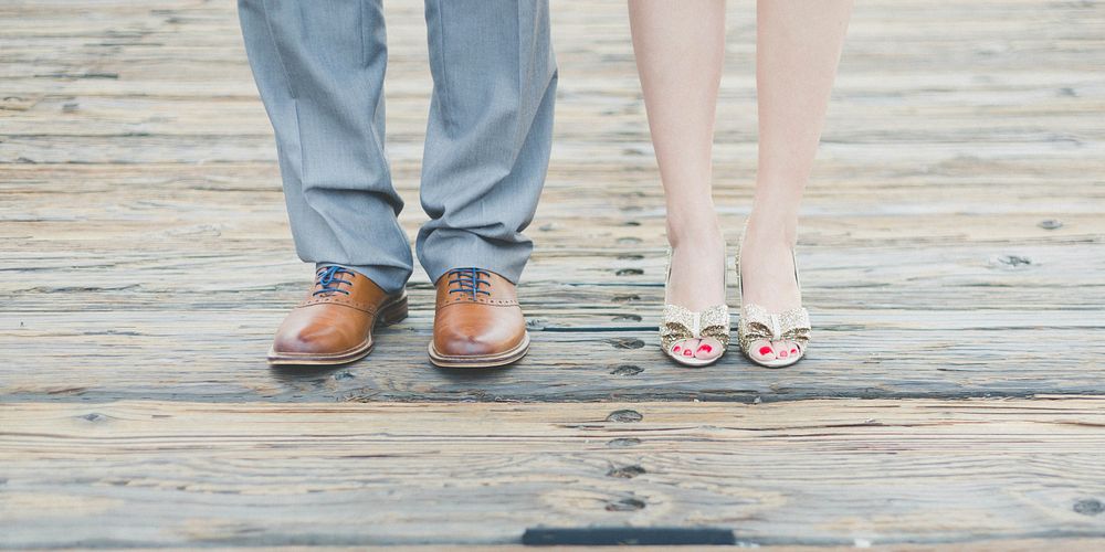 A man and woman's feet in nice shoes and dress pants for a wedding in San Francisco. Original public domain image from…
