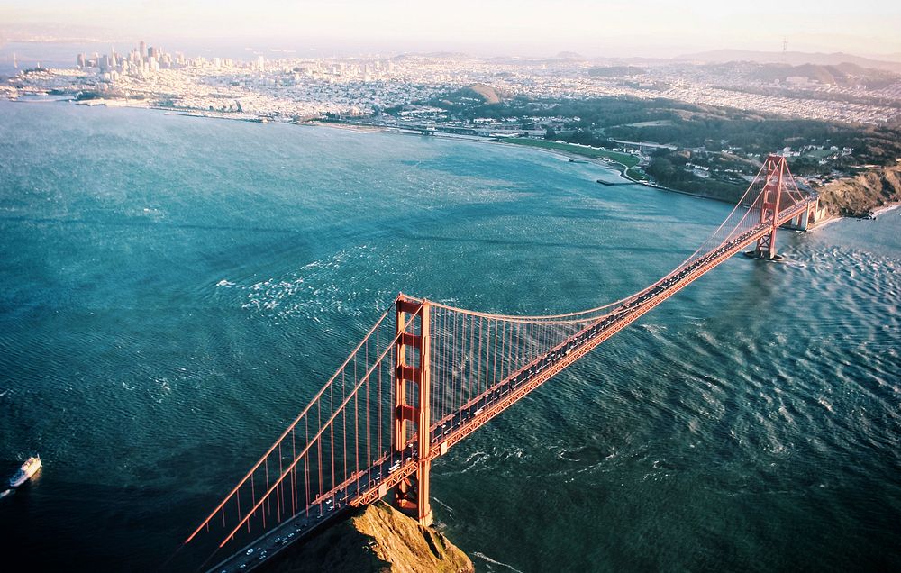 Drone view of San Francisco Golden Gate Bridge over crystal blue water and harbor in background. Original public domain…