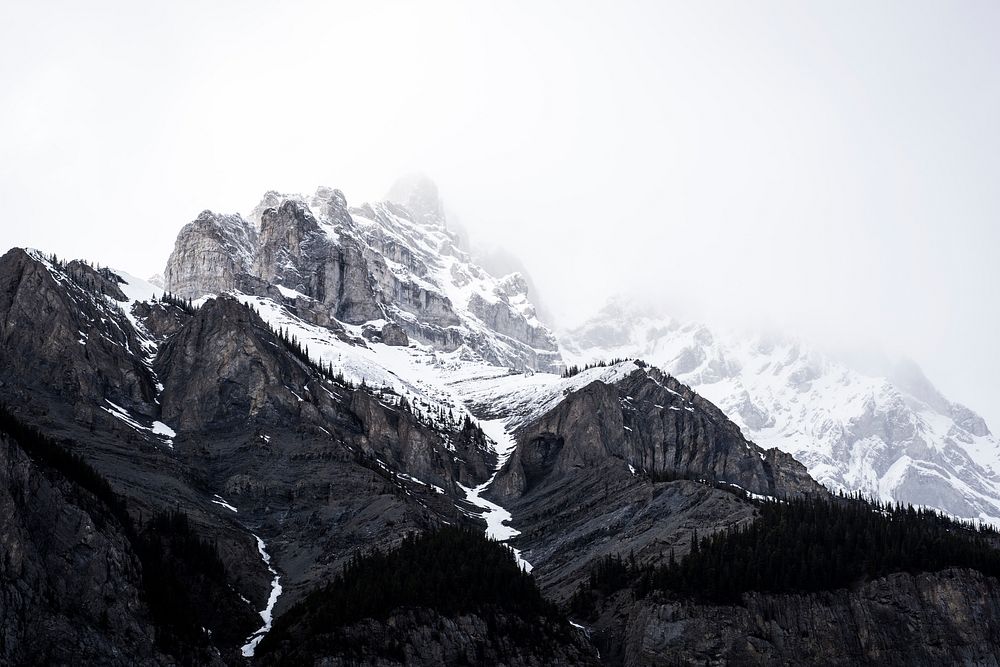 Fog masks the snow capped peaks of Banff. Original public domain image from Wikimedia Commons
