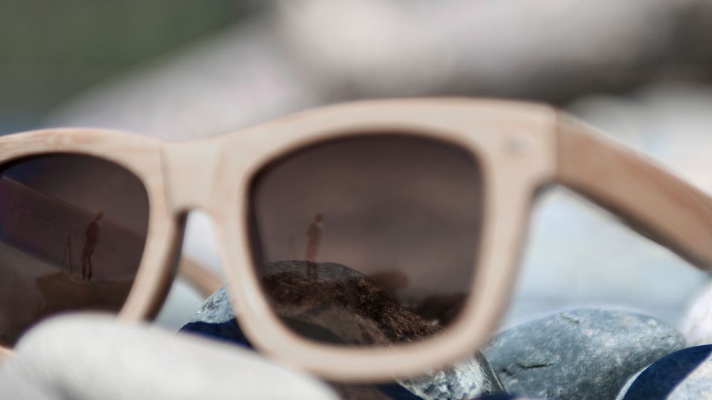 Man reflected in the wooden frame sunglasses on the rock at French Beach. Original public domain image from Wikimedia Commons