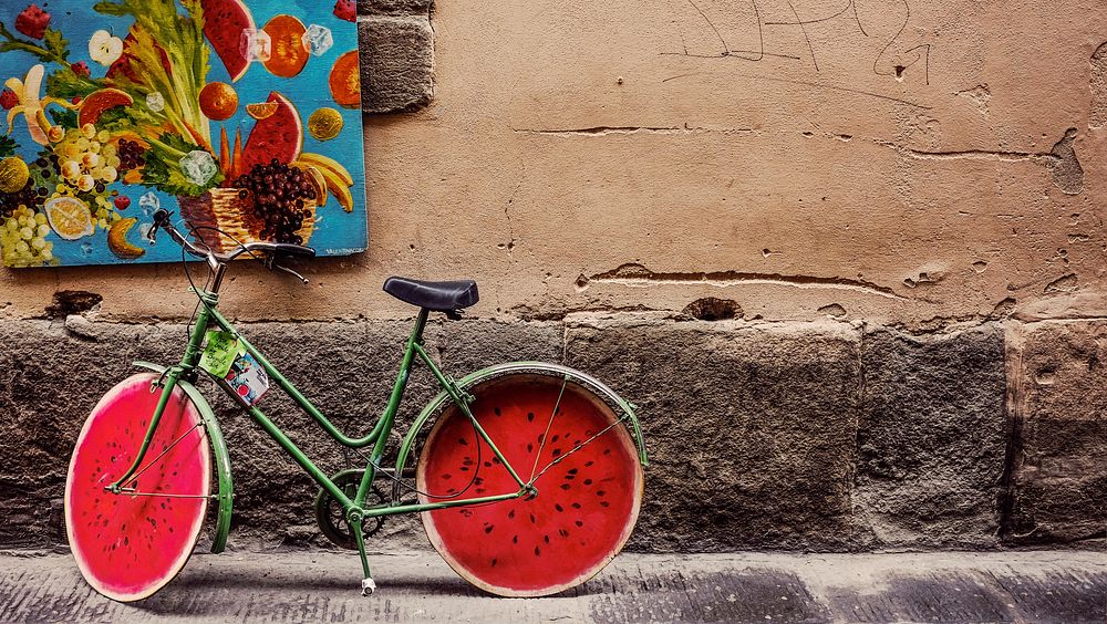 A green bicycle with wheels resembling a cross-section of a watermelon. Original public domain image from Wikimedia Commons