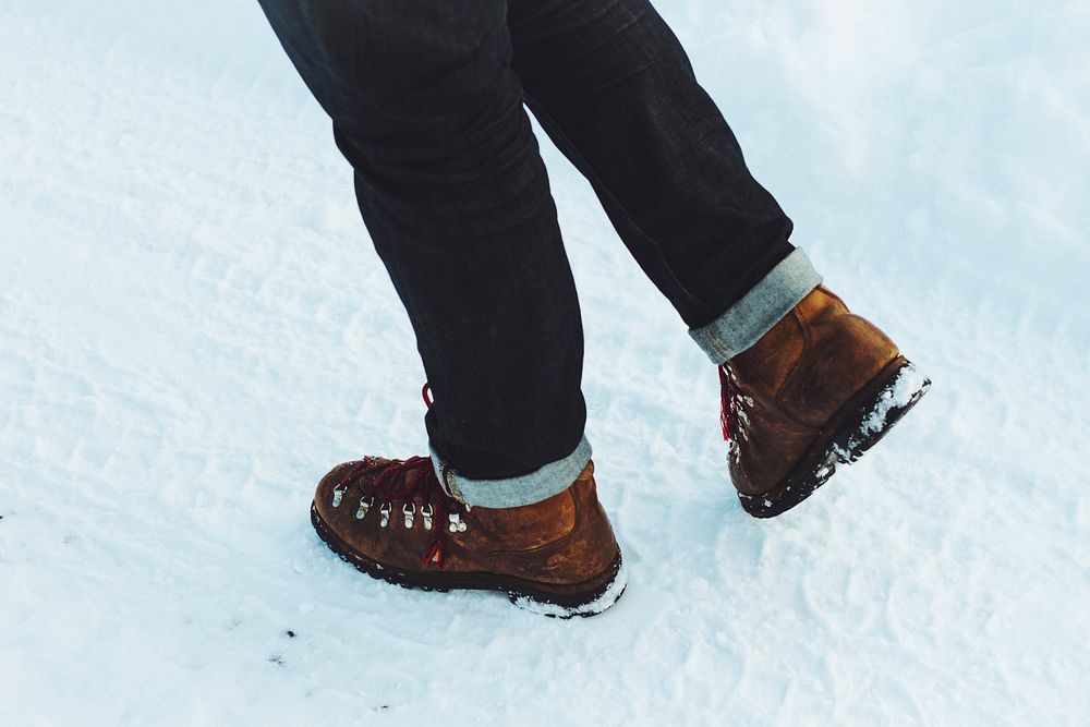 Brown winter fashion boots walking on snow. Original public domain image from Wikimedia Commons