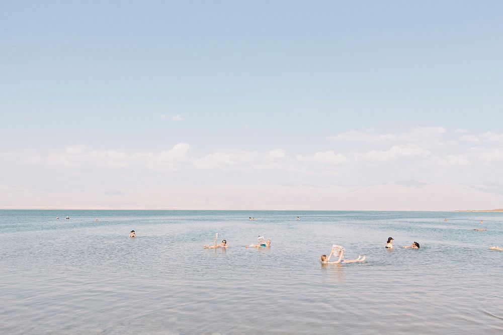 People floating in the very salty water in the Dead Sea. Original public domain image from Wikimedia Commons