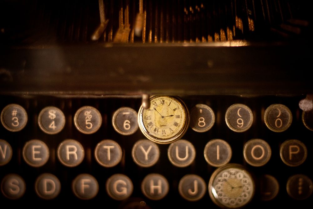 An old pocket watch on a vintage typewriter. Original public domain image from Wikimedia Commons