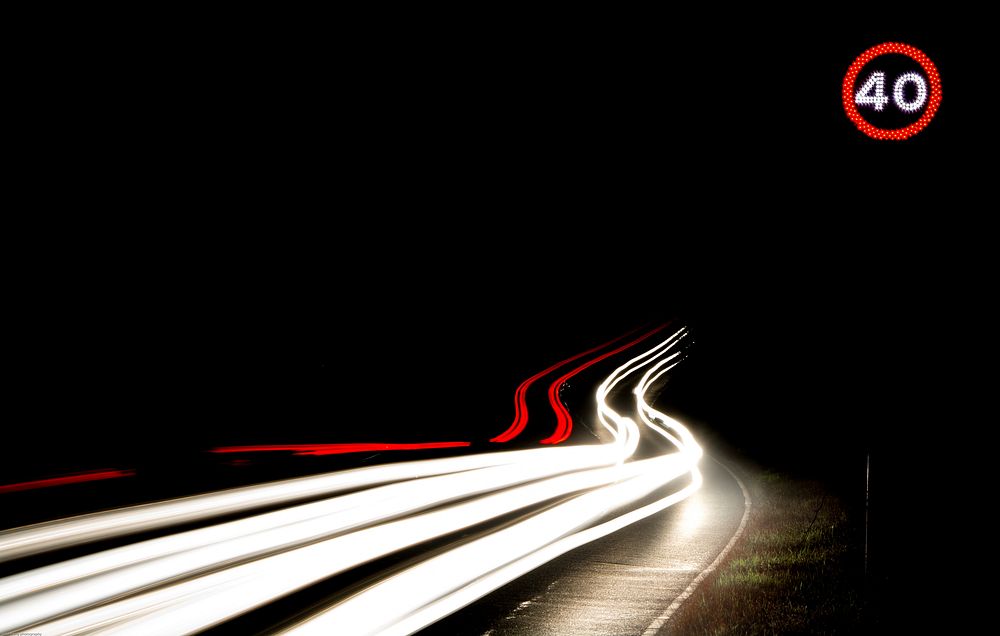 Red and white car light trails on the road at night in Essex. Original public domain image from Wikimedia Commons