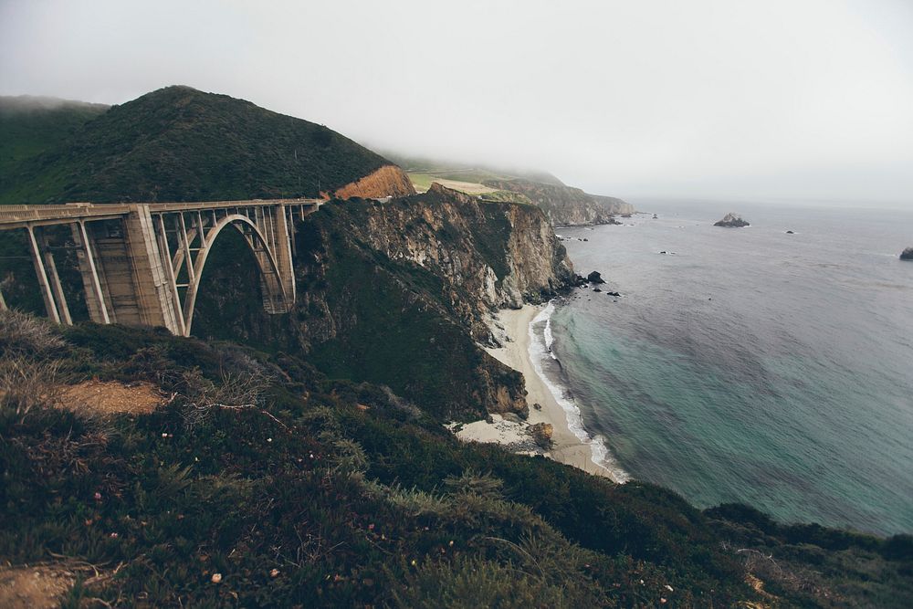 Bixby Creek Bridge in Big Sur overlooking the ocean and sandy beaches. Original public domain image from Wikimedia Commons