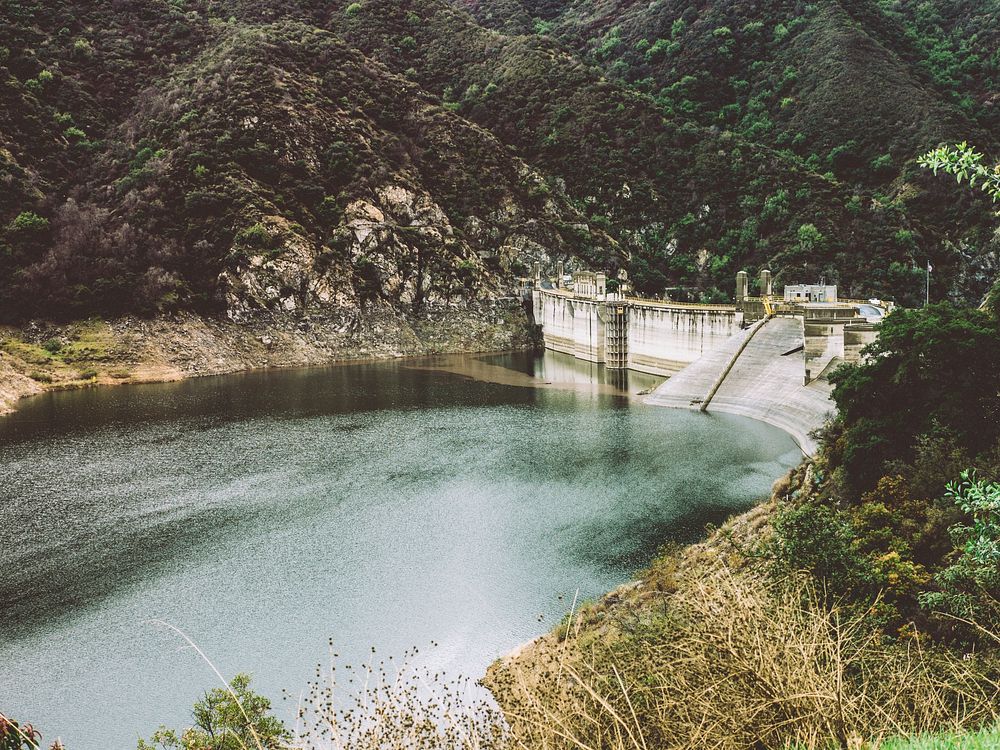 A concrete dam on a mountain lake. Original public domain image from Wikimedia Commons