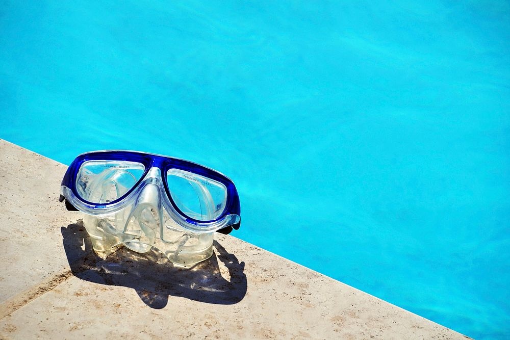 Snorkel goggles on pool edge. Original public domain image from Wikimedia Commons