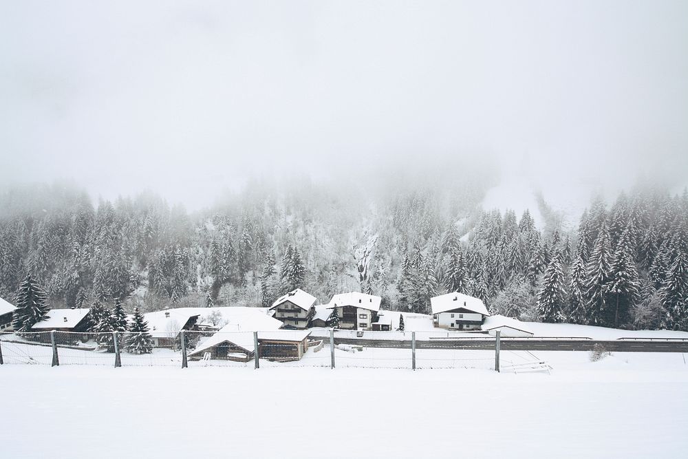 Fog over snow covered cabins near a forest in Finkenberg. Original public domain image from Wikimedia Commons