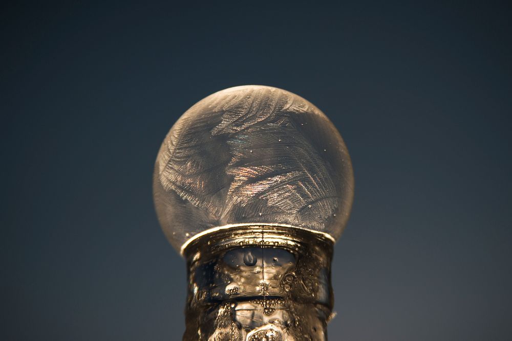 Close-up of a frozen bubble atop a bottle at Billings, Montana, seen against a clear sky. Original public domain image from…