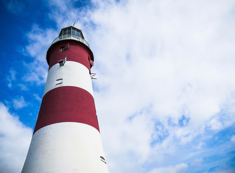 A lighthouse painted in red and white stripes. Original public domain image from Wikimedia Commons