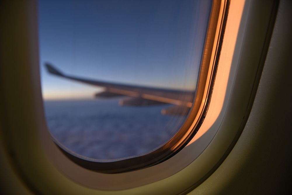 A blurry view from an oval plane window. Original public domain image from Wikimedia Commons