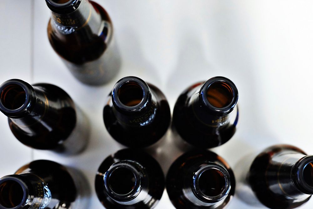 The macro view of the top of open and empty beer bottles. Original public domain image from Wikimedia Commons