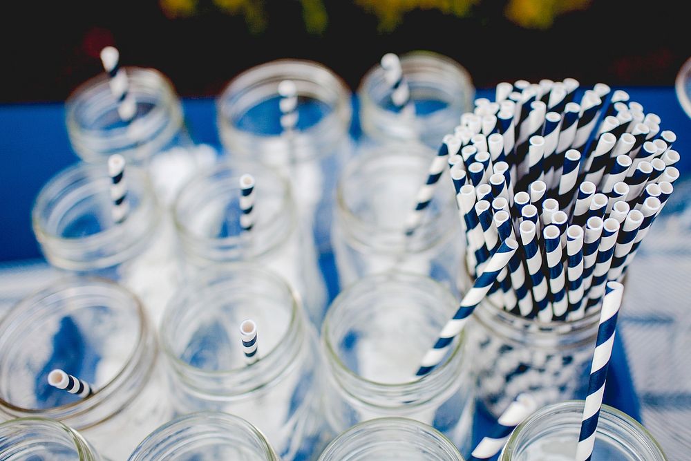 A selection of Mason jars with blue and white striped straws, ahead of a party. Original public domain image from Wikimedia…