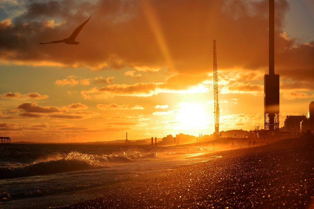 sunlight from sunset carves out silhouette of beach in Brighton construction site. Original public domain image from…