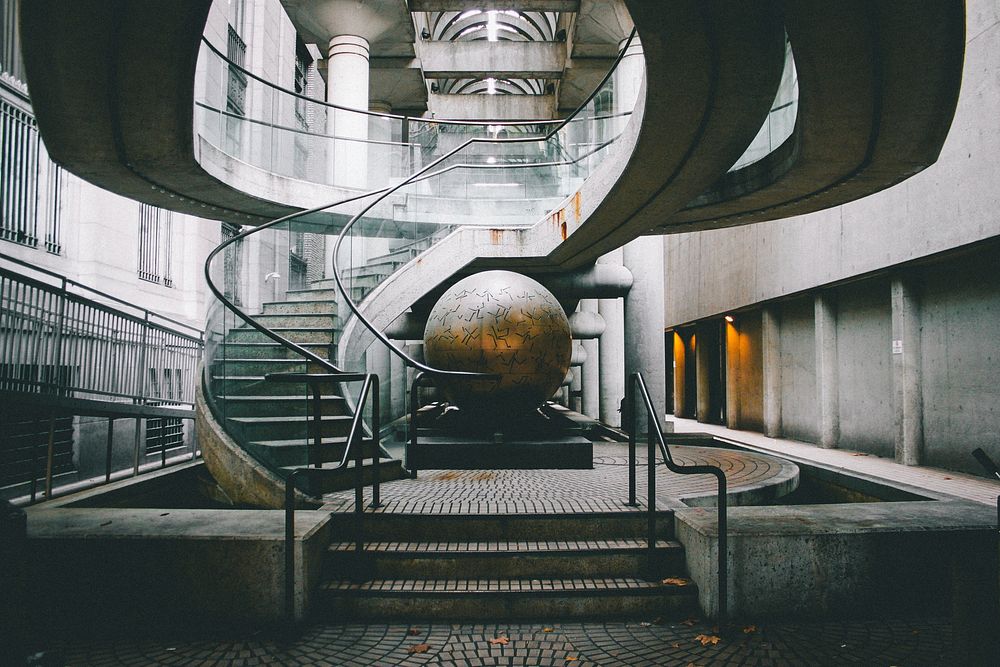 A large metal sphere near a winding staircase in a building. Original public domain image from Wikimedia Commons