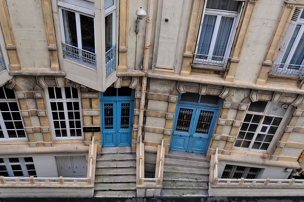 An overhead shot of old buildings with blue doors in Rue Gustave Rouland.. Original public domain image from Wikimedia…