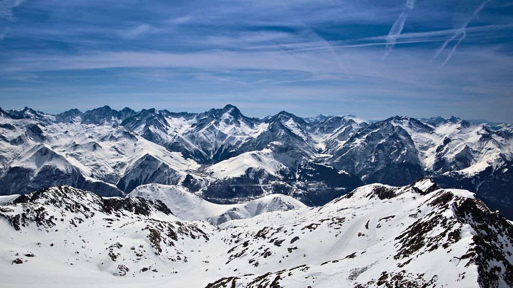 Sharp snow-covered mountain peaks stretching to the horizon. Original public domain image from Wikimedia Commons