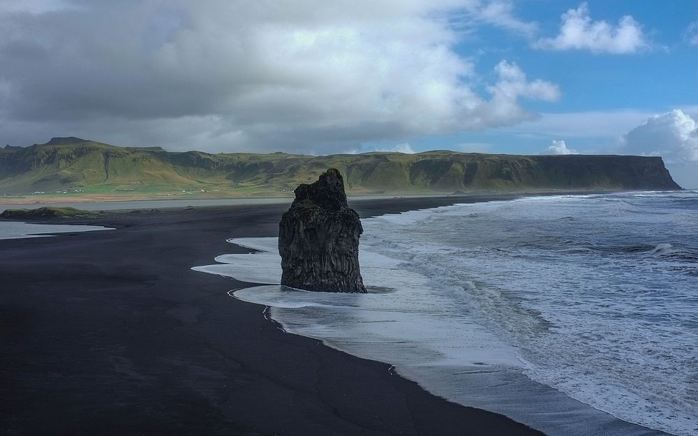 Large rock on the black sand beach in Reynisfjara. Original public domain image from Wikimedia Commons