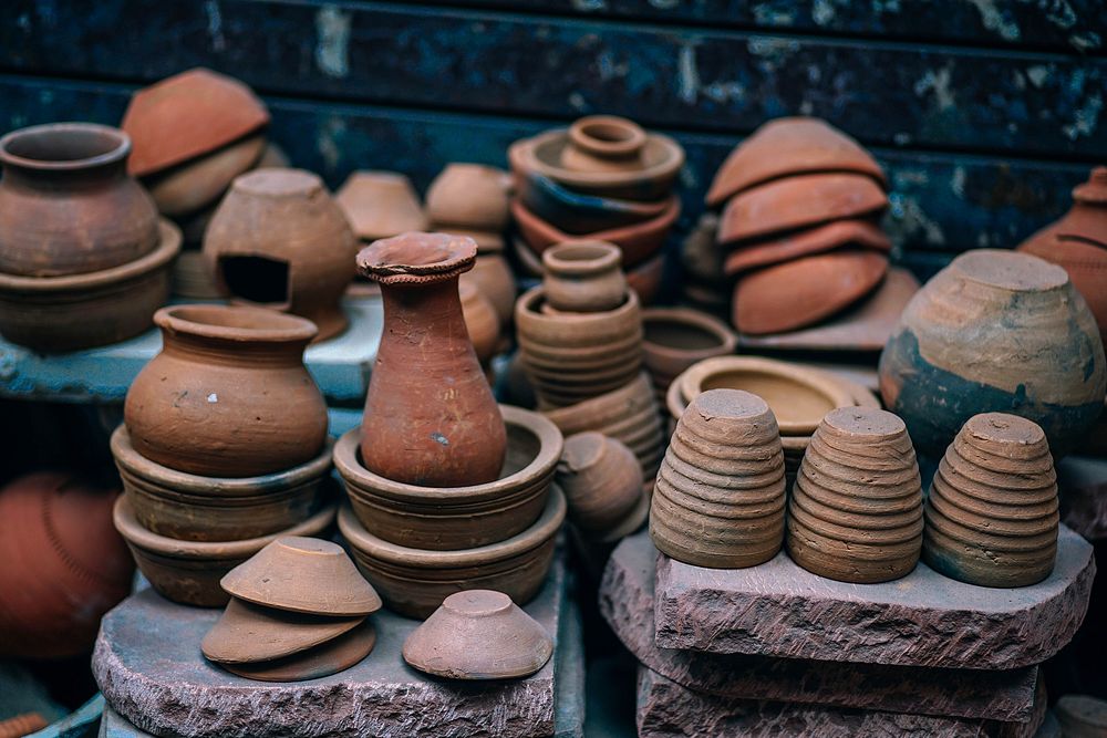 Stacks of pottery near a wall. Original public domain image from Wikimedia Commons