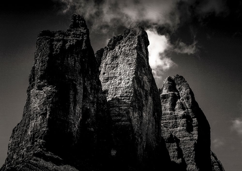 Eerie rock formations against a stormy dark sky. Original public domain image from Wikimedia Commons