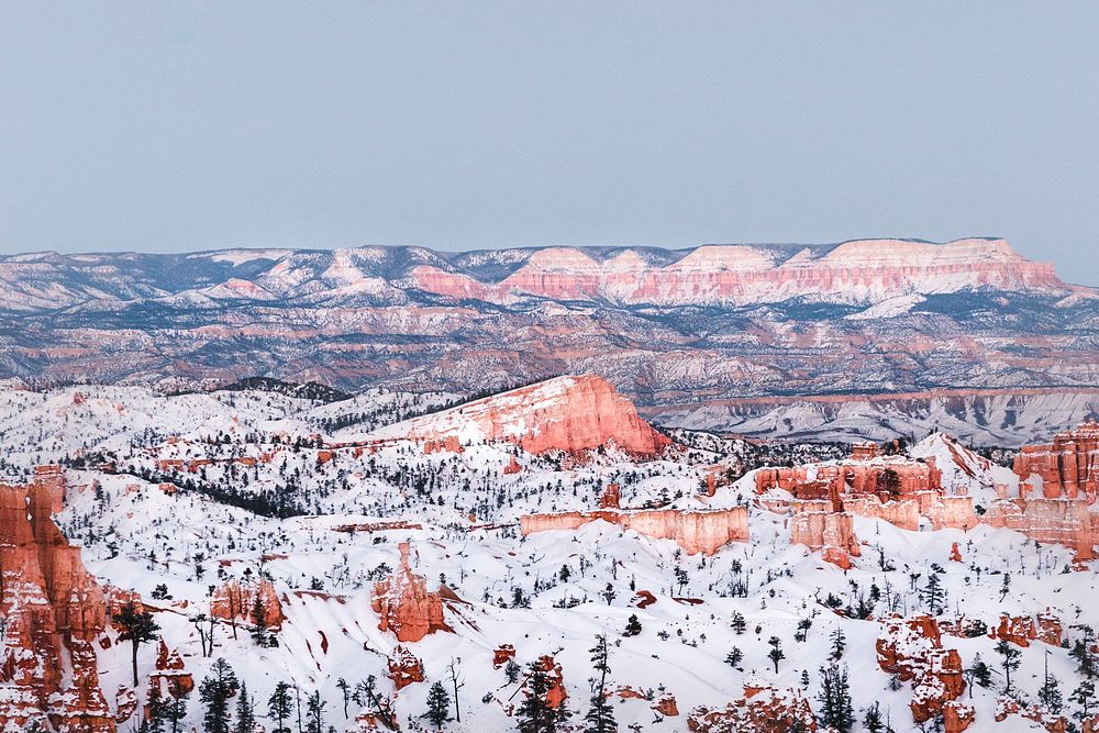 A shot overlooking Bryce Canyon and nearby mountains during the winter season. Original public domain image from Wikimedia…
