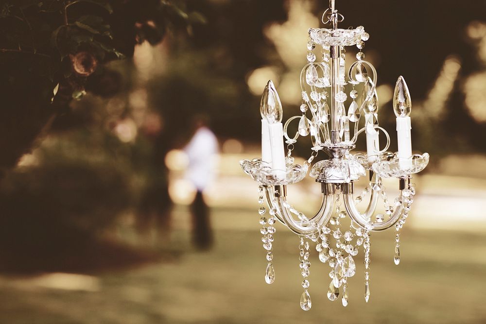 A crystal chandelier hangs in a garden.. Original public domain image from Wikimedia Commons