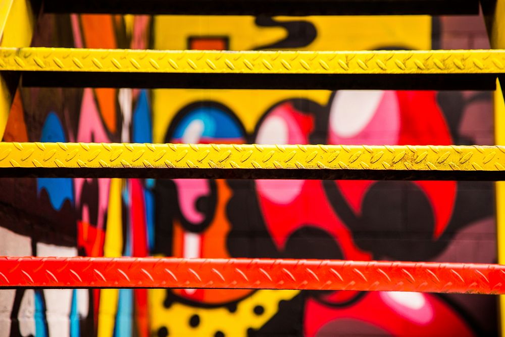 Close up of spray painted metal urban stairs with colorful graffiti in background, Windsor. Original public domain image…