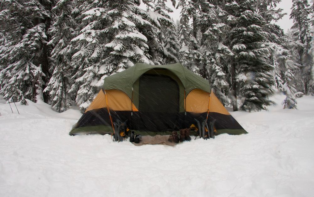 A green and orange tent for camping in the snow at Stevens Pass, Washington. Original public domain image from Wikimedia…