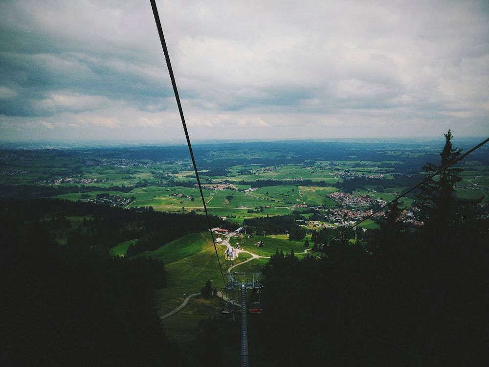 View from a chairlift on green countryside below. Original public domain image from Wikimedia Commons