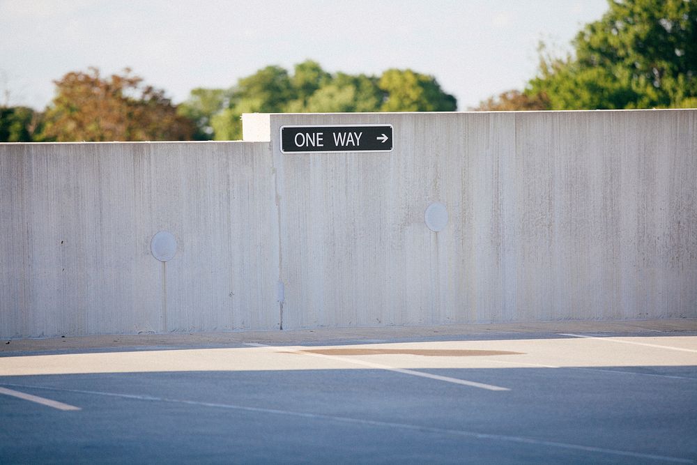A “one way” sign at a parking lot. Original public domain image from Wikimedia Commons