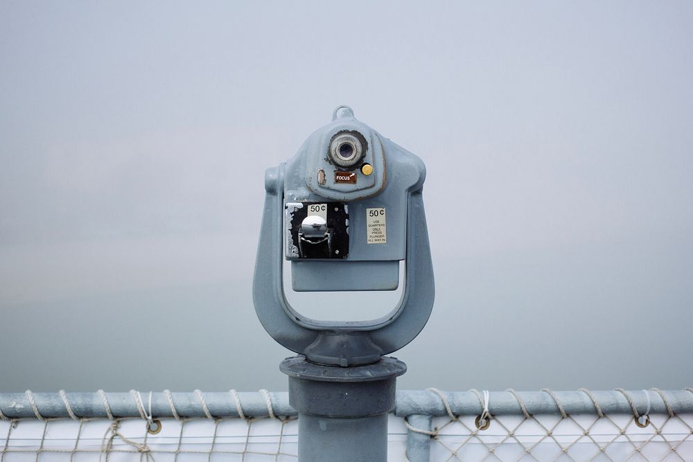 A tower viewer at the edge of an observation deck on a misty day. Original public domain image from Wikimedia Commons