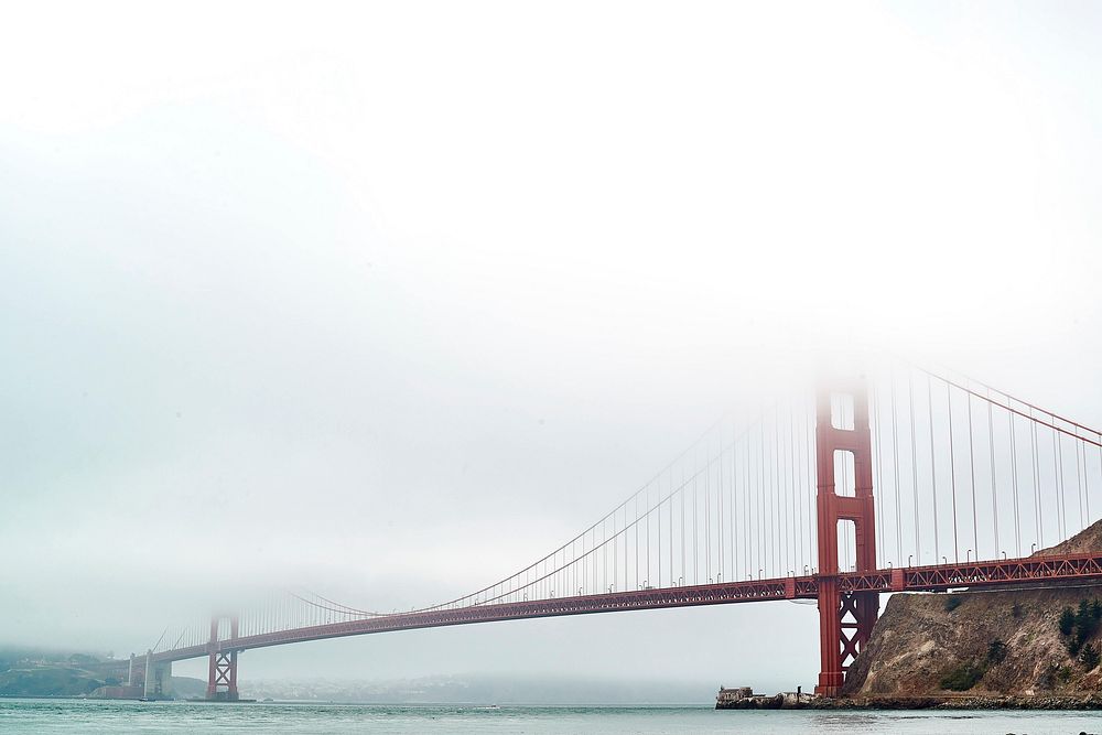 Foggy view of iconic landmark Golden Gate Bridge. Original public domain image from Wikimedia Commons