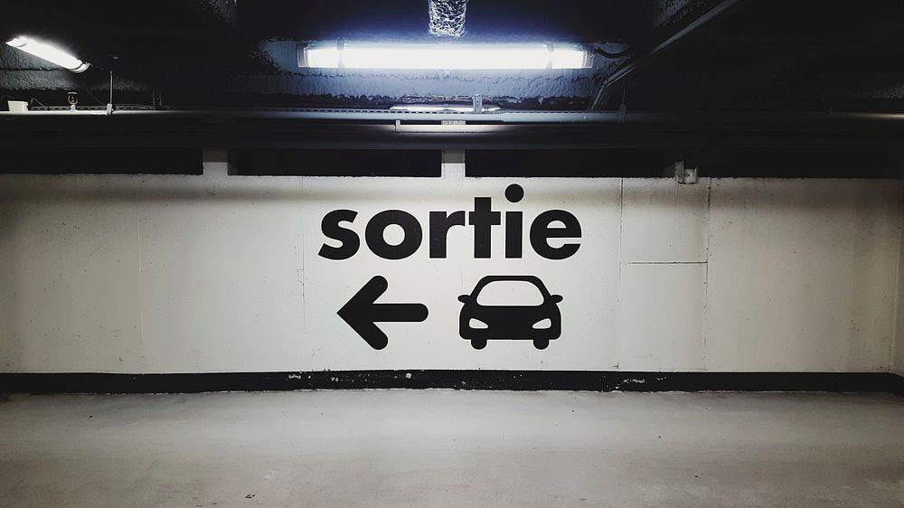 French exit sign and light in urban underground car park, Parking du Centre Commercial La Part-Dieu. Original public domain…
