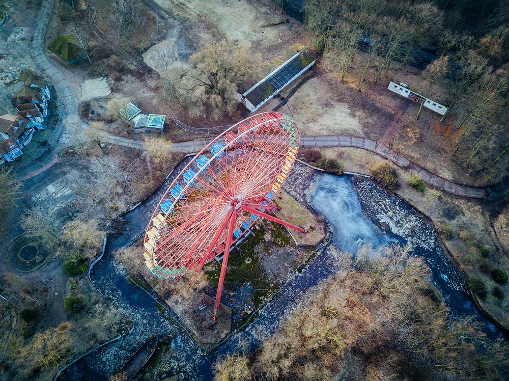A drone shot of a red Ferris wheel in a desolate area. Original public domain image from Wikimedia Commons