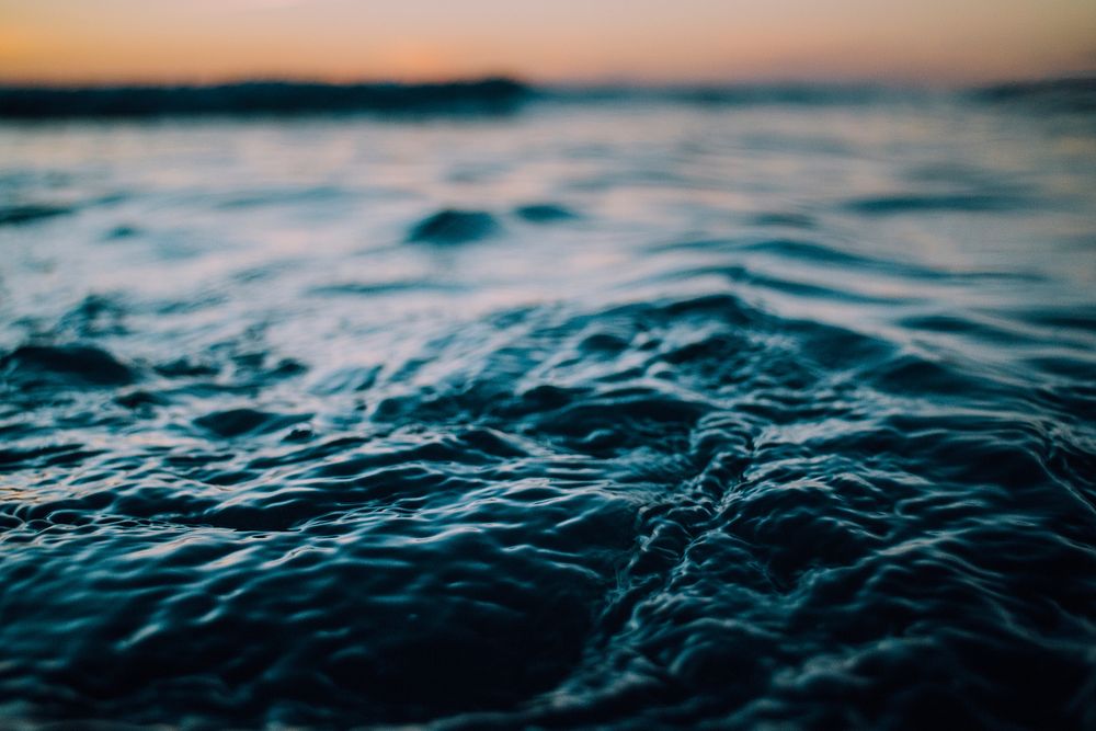 Ocean waves rippling after sunset at Piha Beach. Original public domain image from Wikimedia Commons