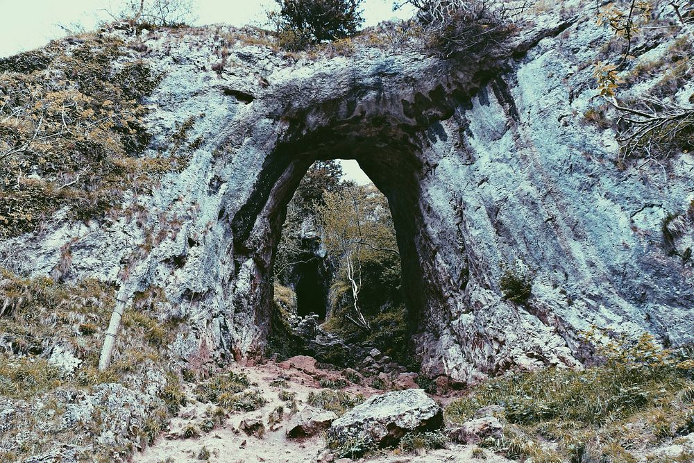 View of a cave entrance through a hollow rock. Original public domain image from Wikimedia Commons