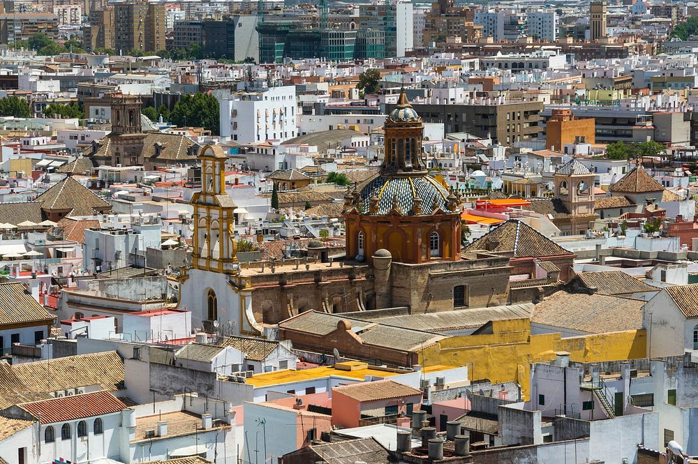 The church "Santa Cruz" merging from roofs, seen from the "Giralda, Seville, Spain. Original public domain image from…