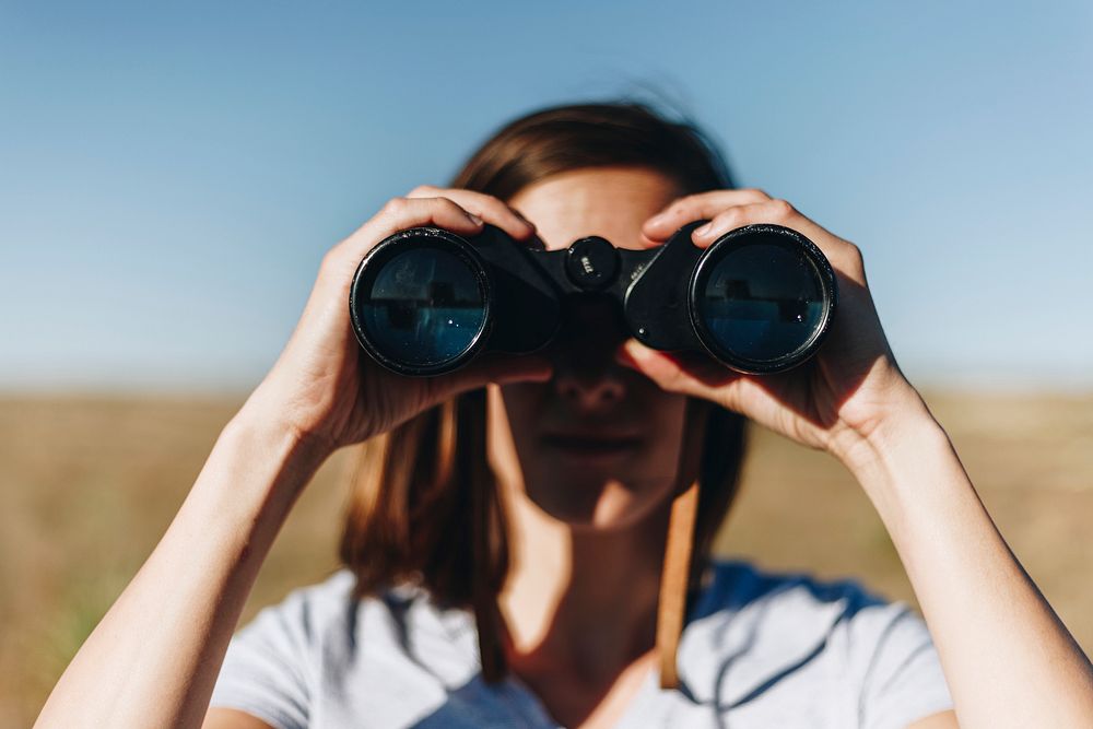Traveler spying through binoculars