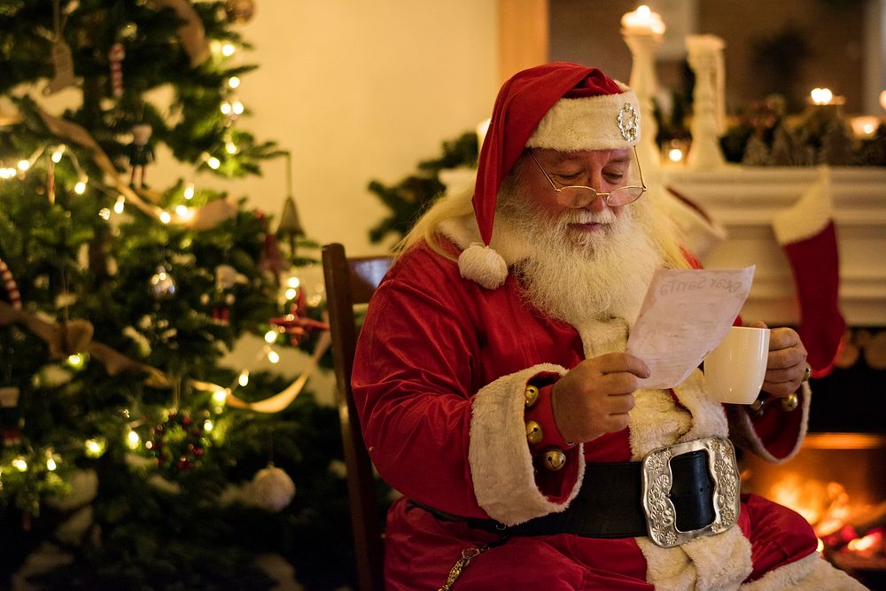 Santa claus reading a Christmas wishlist