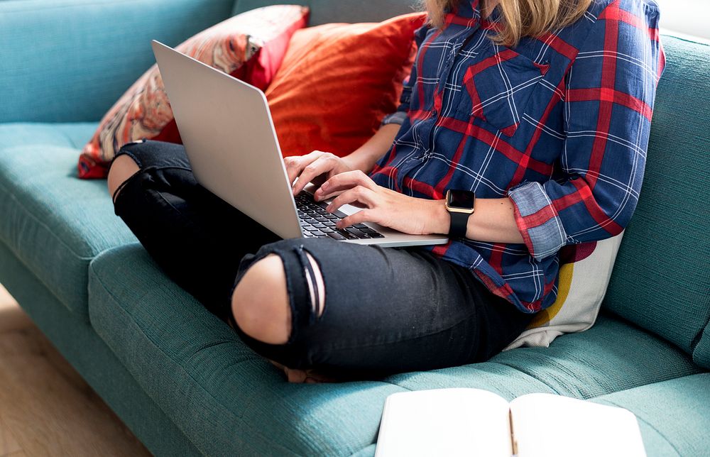 Caucasian woman using computer laptop on the couch